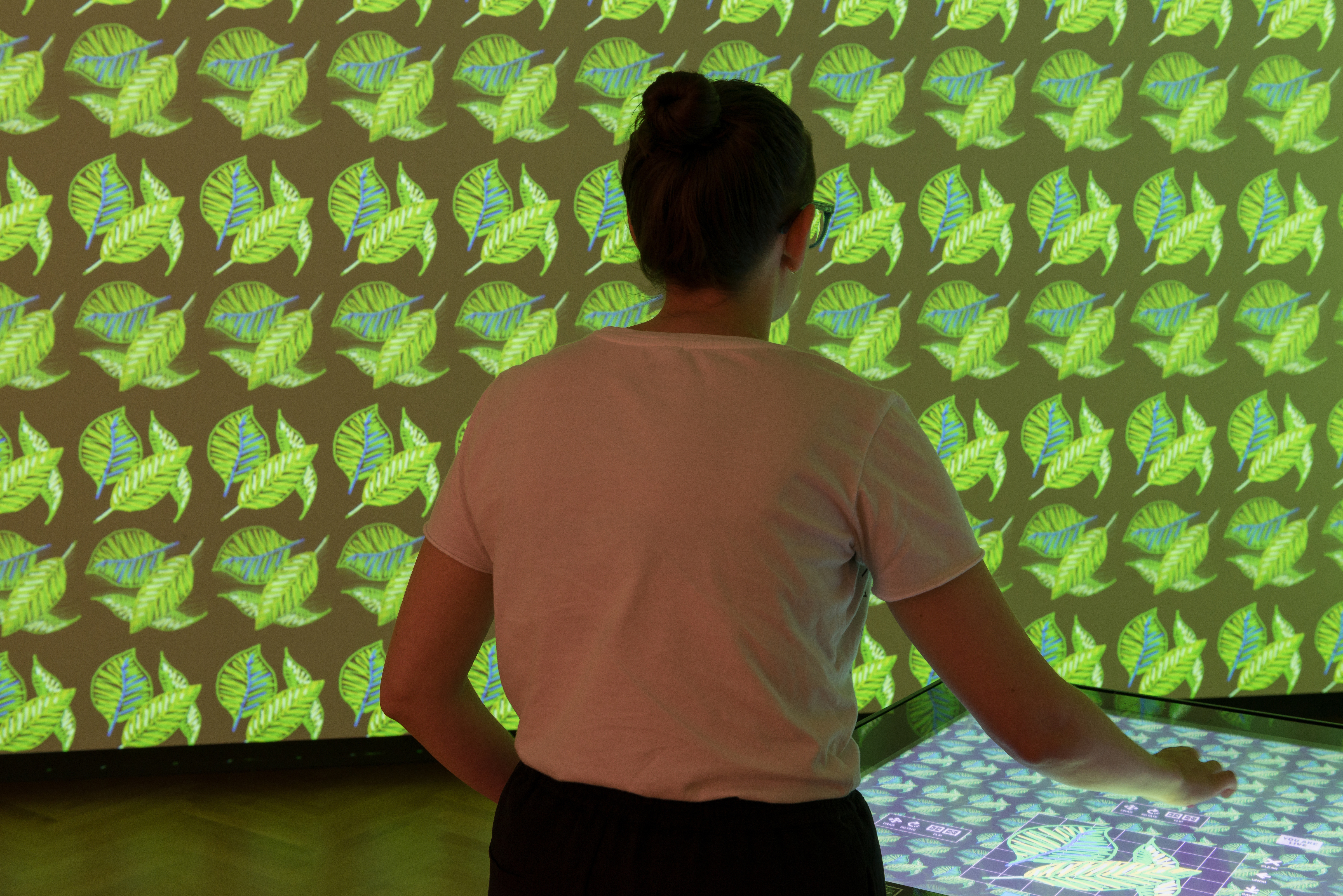 A visitor to Cooper Hewitt's Immersion Room explores the museum's collection of wallpaper, the largest in North America. (Photo by Matt Flynn © 2015 Cooper Hewitt, Smithsonian Design Museum.)