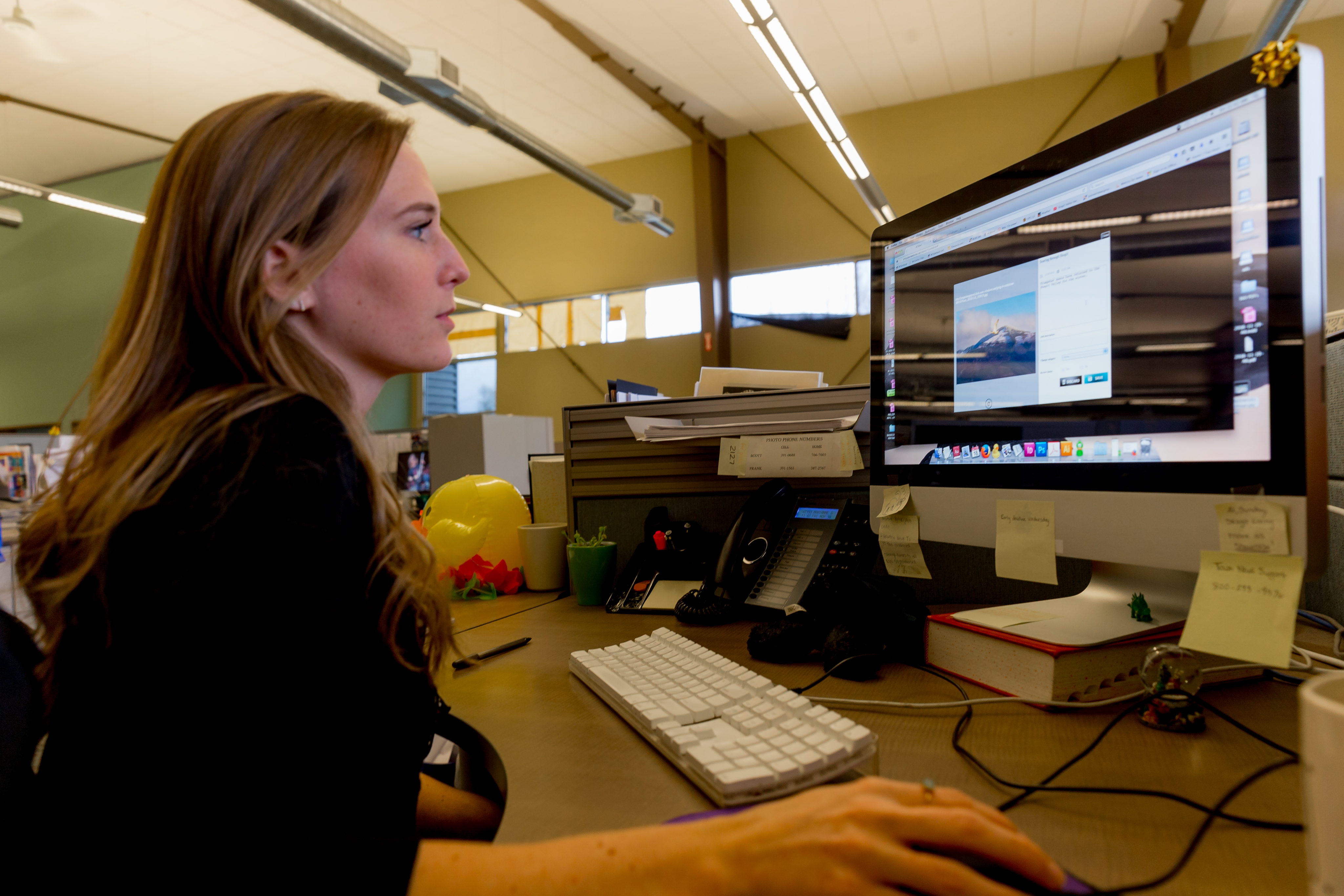 Marianne Graff, social editor for the Skagit Valley Herald, reviews one of the photos Chuck Mell submitted through the uReporter app for possible publication. (Photo by Scott Eklund/Red Box Pictures)