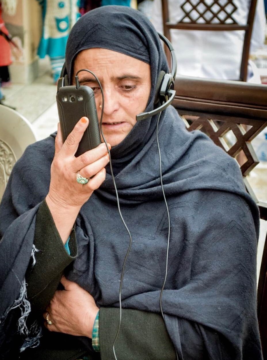 Equipped with a mobile device and headphones, a patient experiences her first virtual consultation. (Photo courtesy of RingMD)