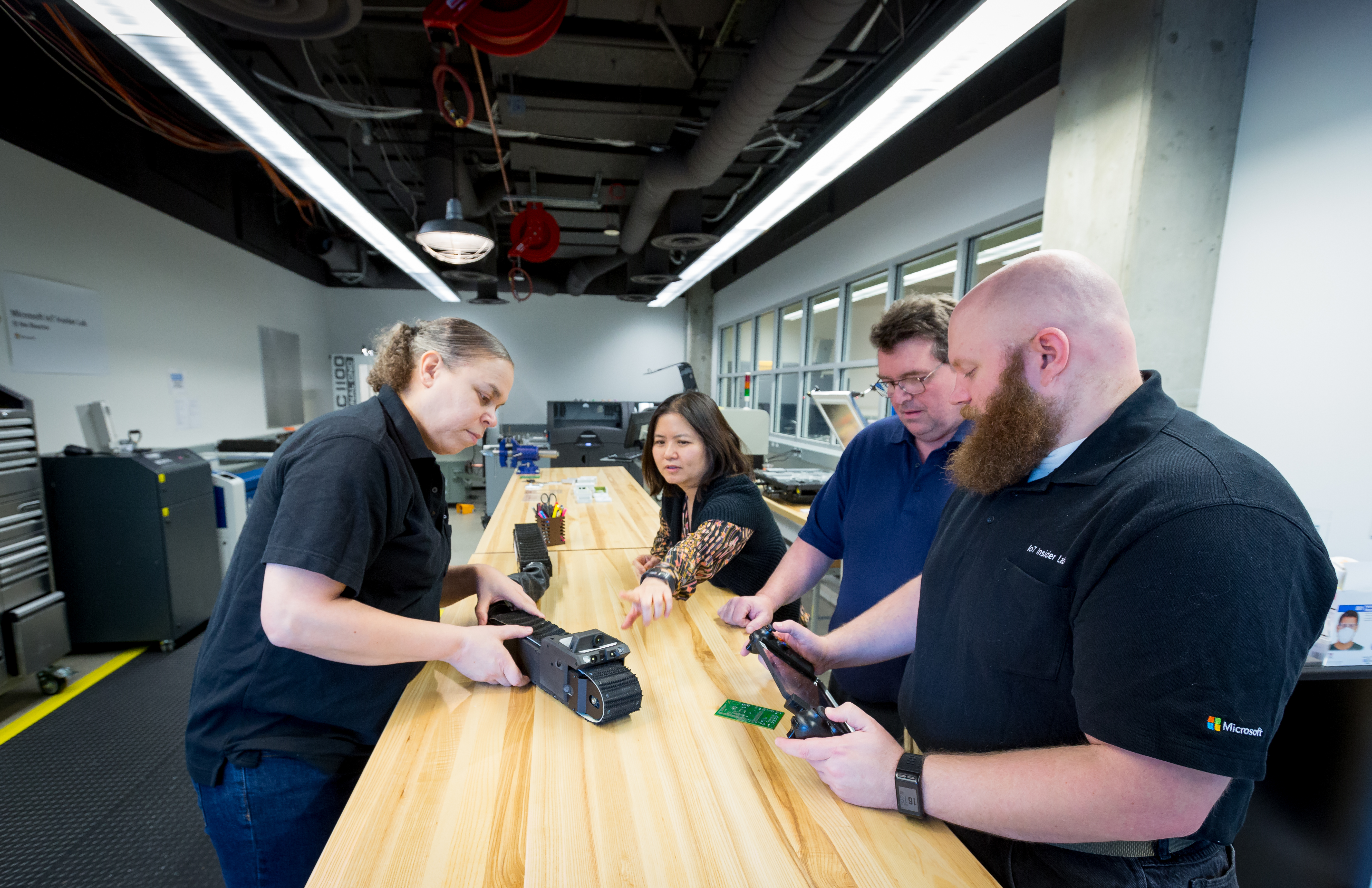 Engineers at Microsoft’s IoT & AI Insider Lab in Redmond inspect the Sarcos Guardian S robot.