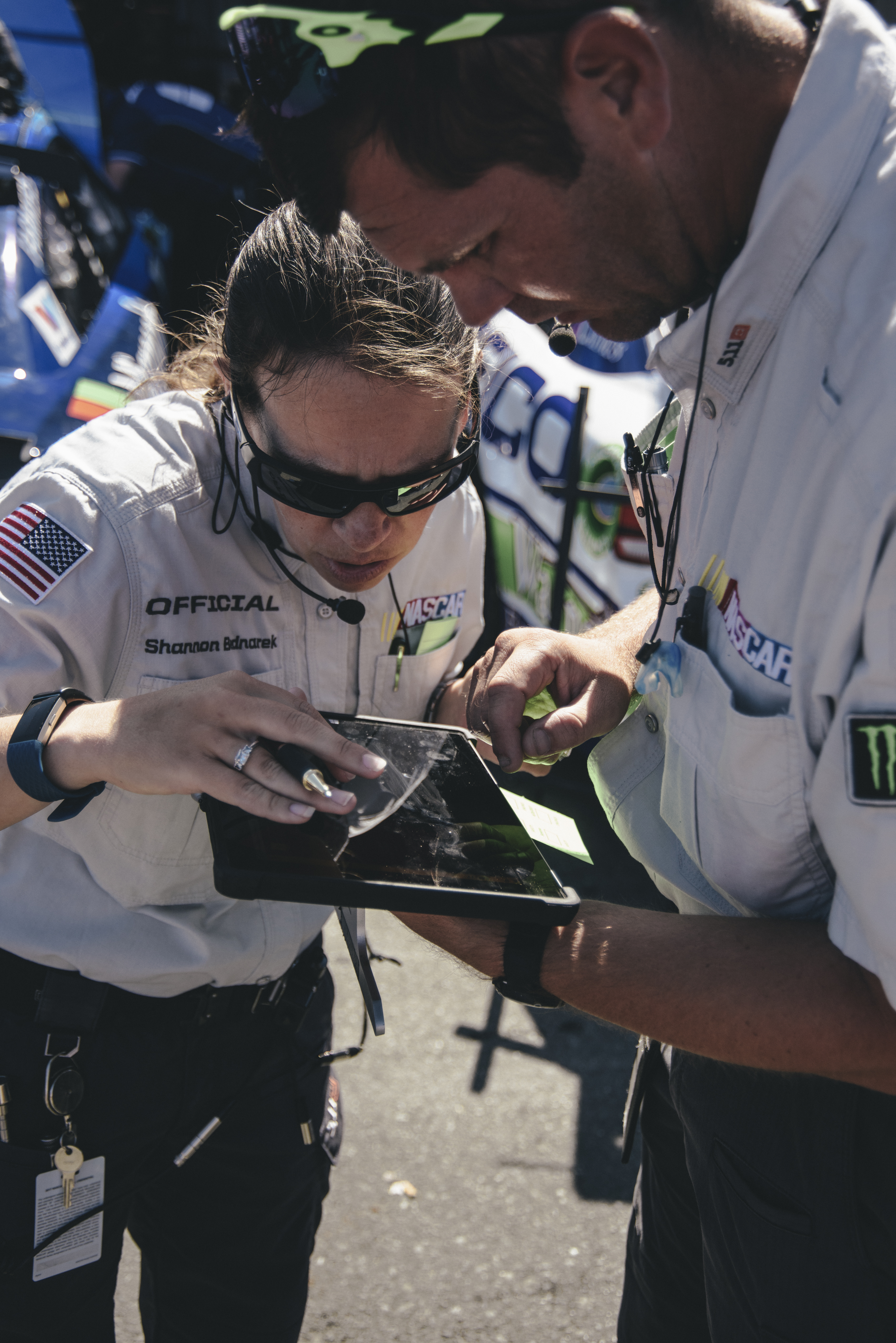 NASCAR officials use a tablet to keep the race safe. (Photo by Integrated Talent)