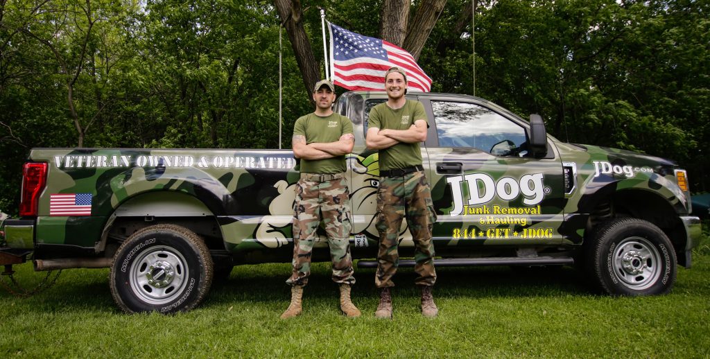 Andrew Weins and his brither Issac standing in front of a JDog pickup truck.