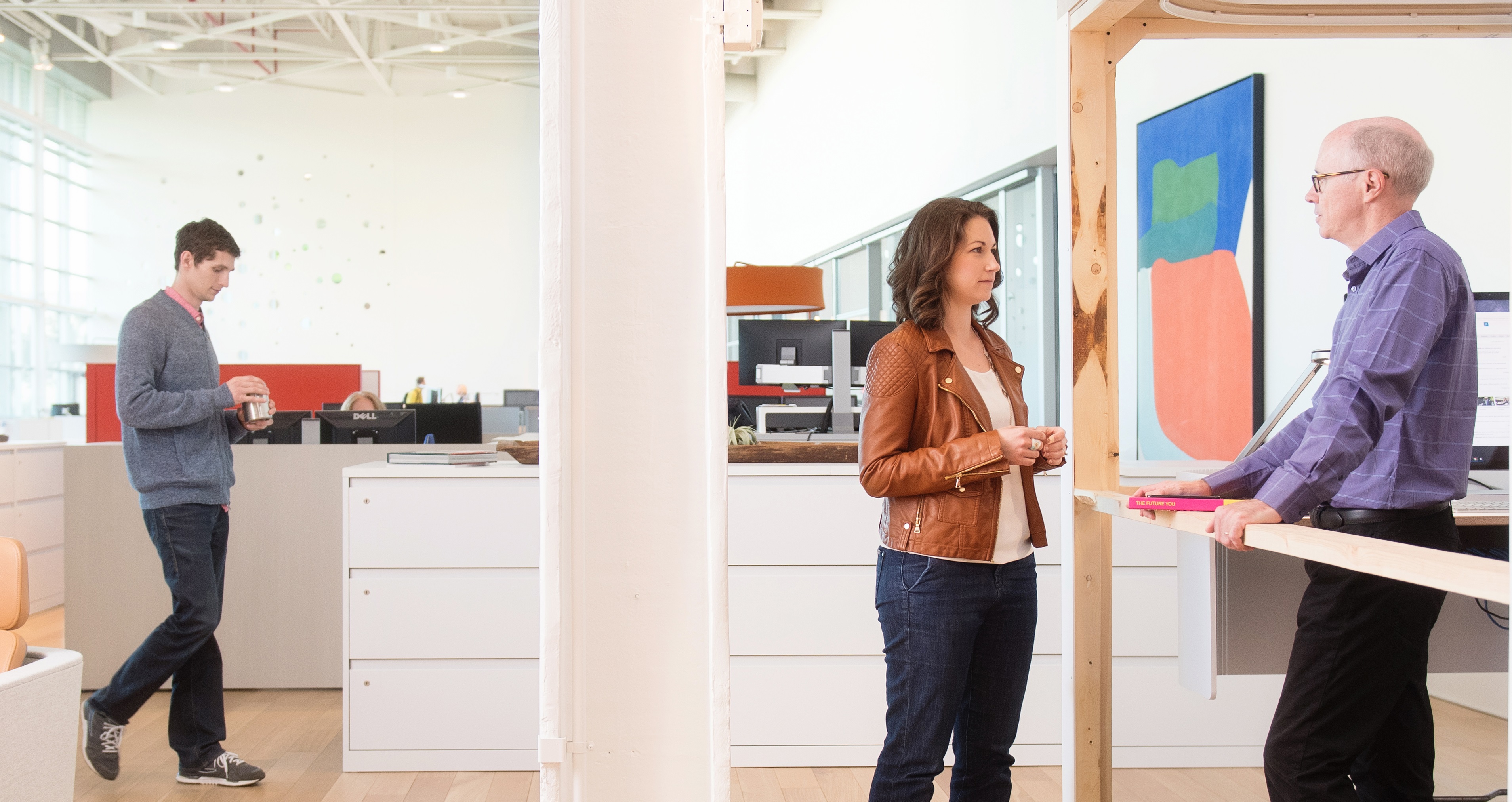 Steelcase CEO Jim Keane speaks with a colleague from an early iteration of his prototype office. 