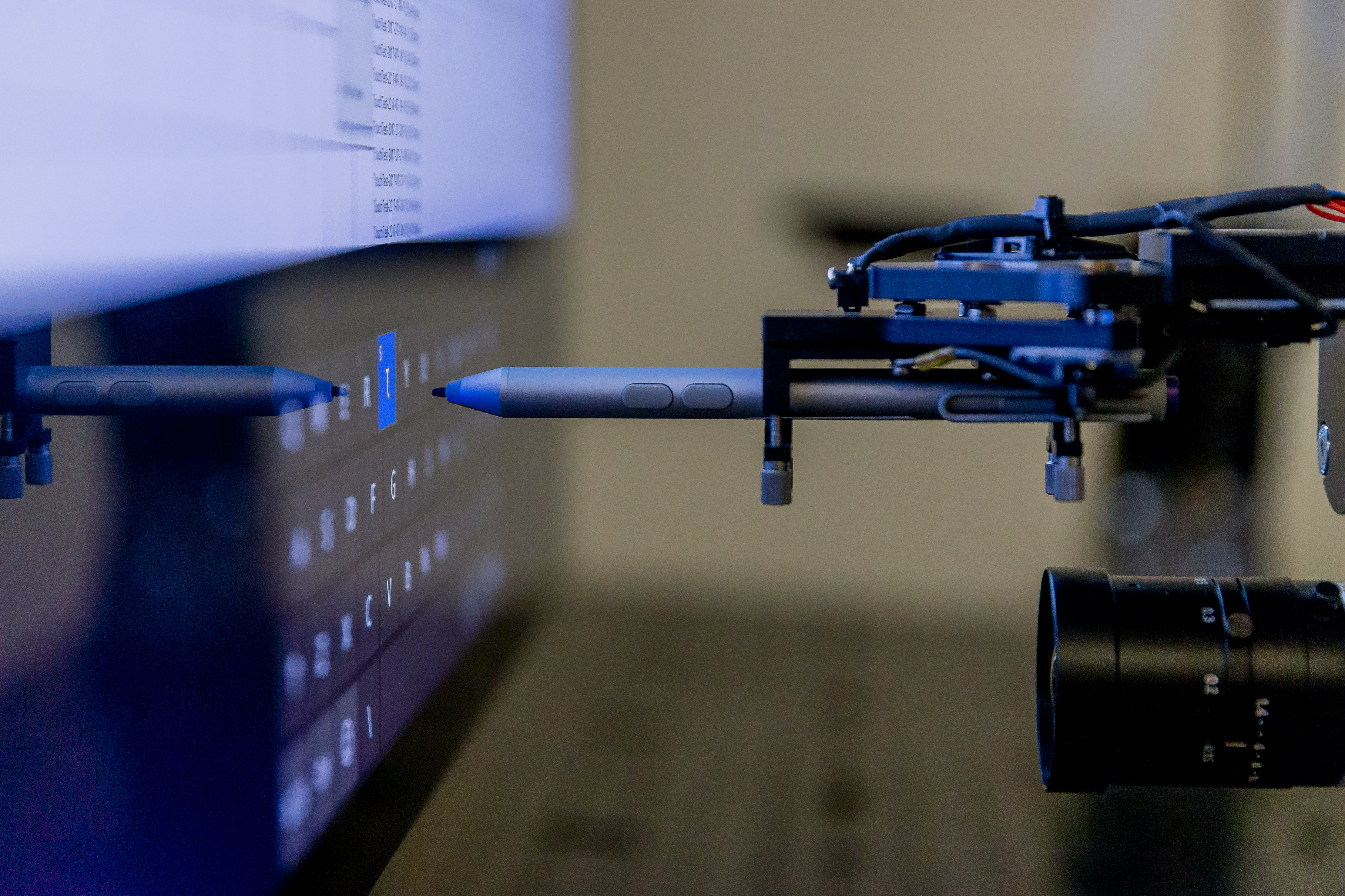 A Surface Pen, guided by a robotic arm, presses every button on a Surface device – over and over for weeks.
