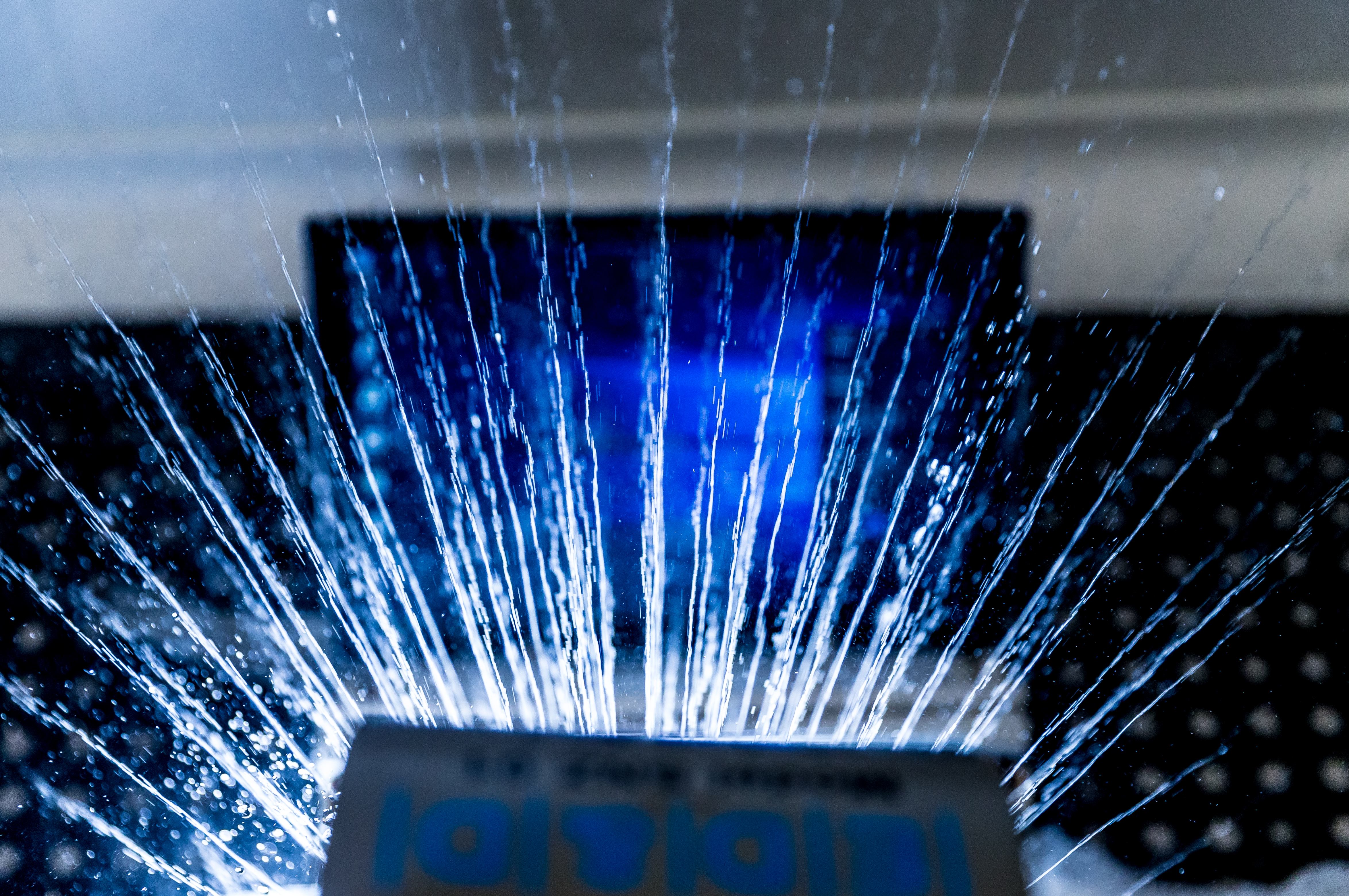 Testers spray water on a Surface device, reproducing a lifetime of rain exposure.