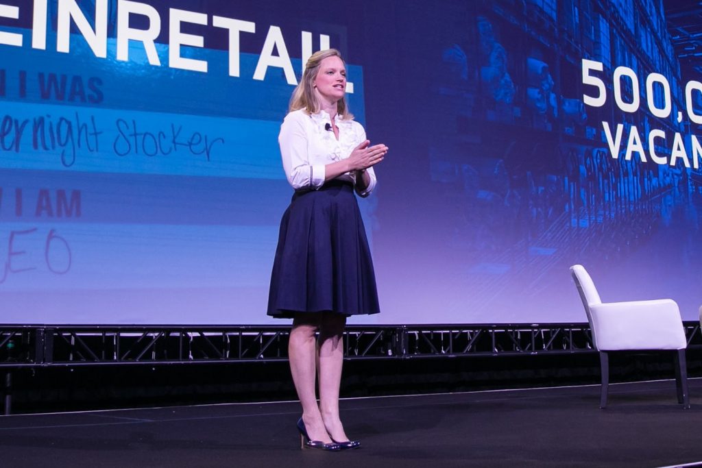 Ellen Davis speaks on stage.