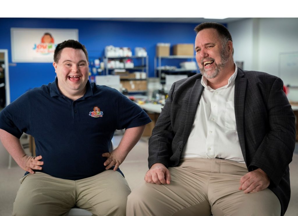 father and son smile side by side