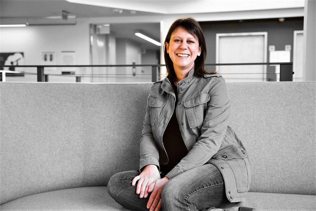woman sitting on a gray couch