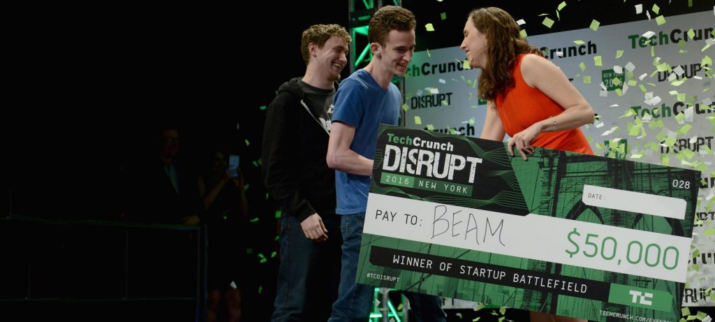 James Boehm and Matt Salsamendi accepting a check from Sam O'Keefe onstage during TechCrunch Disrupt NY 2016; photo by Noam Galai/Getty Images for TechCrunch