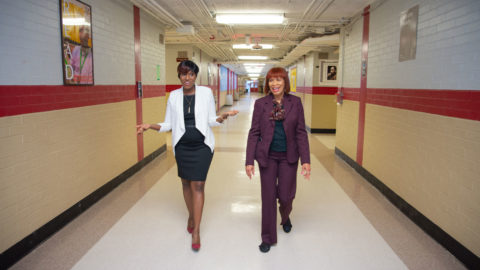 A photo of India Powell and Ms. Northern walking down the hallways of Raines High School.