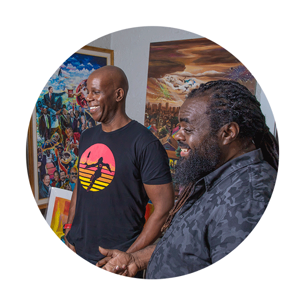 Two men laughing in an art studio