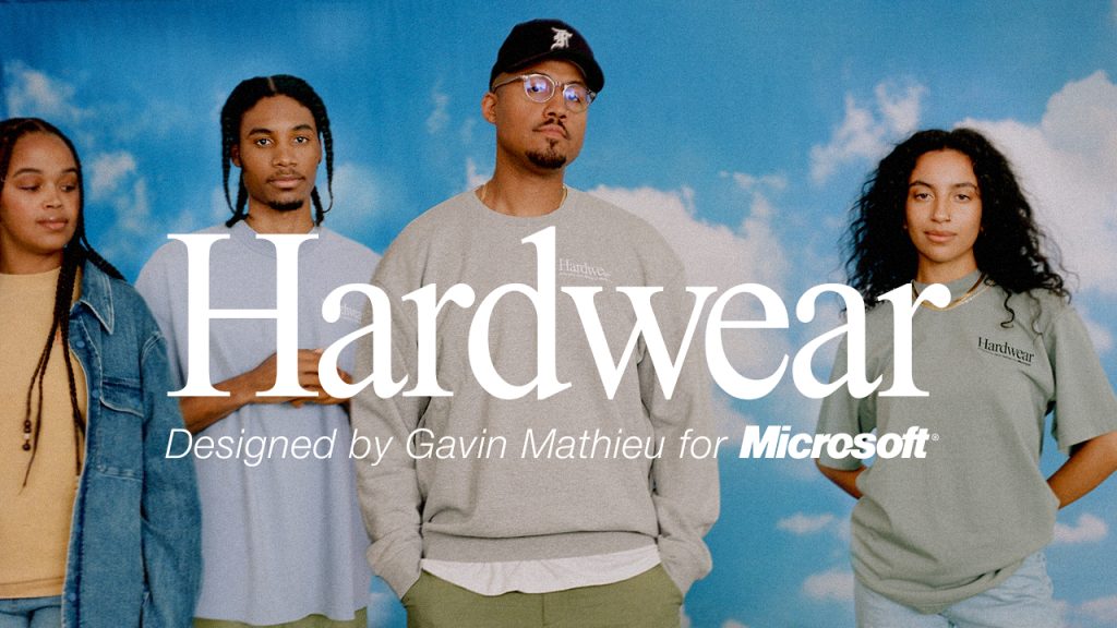 Gavin and three models wearing the Hardwear collection, in front of a blue sky background.