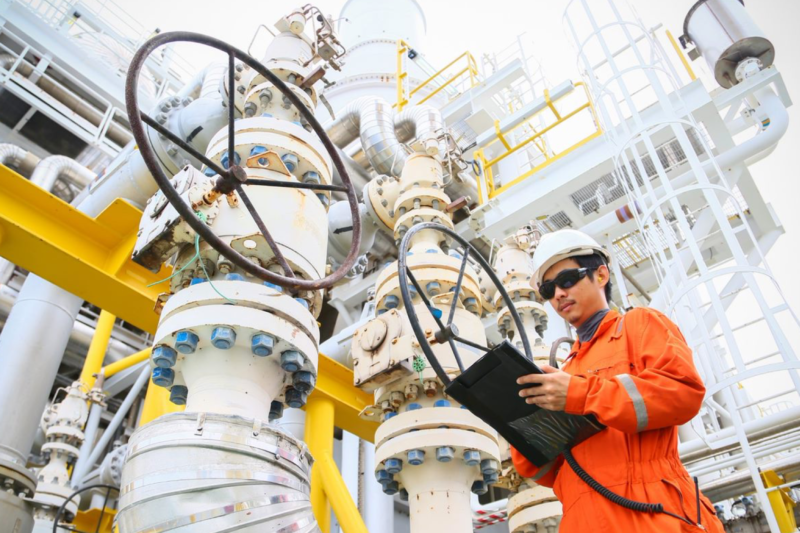 a man works with technology on a refinery