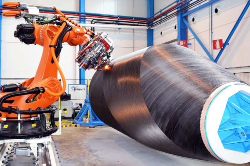 a robot works on a piece of machinery