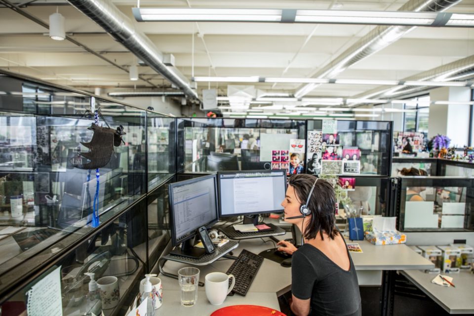 A woman sitting in an office in front of her desk.