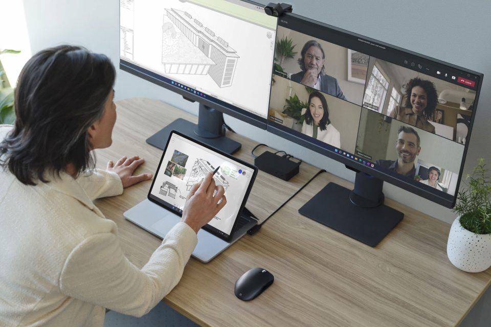 Person sitzt an ihrem Schreibtisch und hält ein Teams-Meeting ab