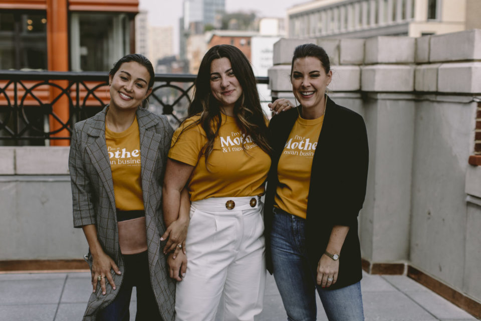 Tres mujeres posan con playeras amarillas
