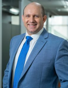 Hombre frente a la cámara con traje y corbata