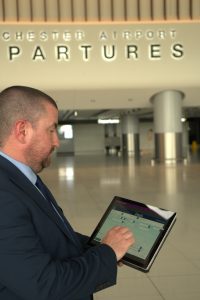 homem em aeroporto com note em mãos