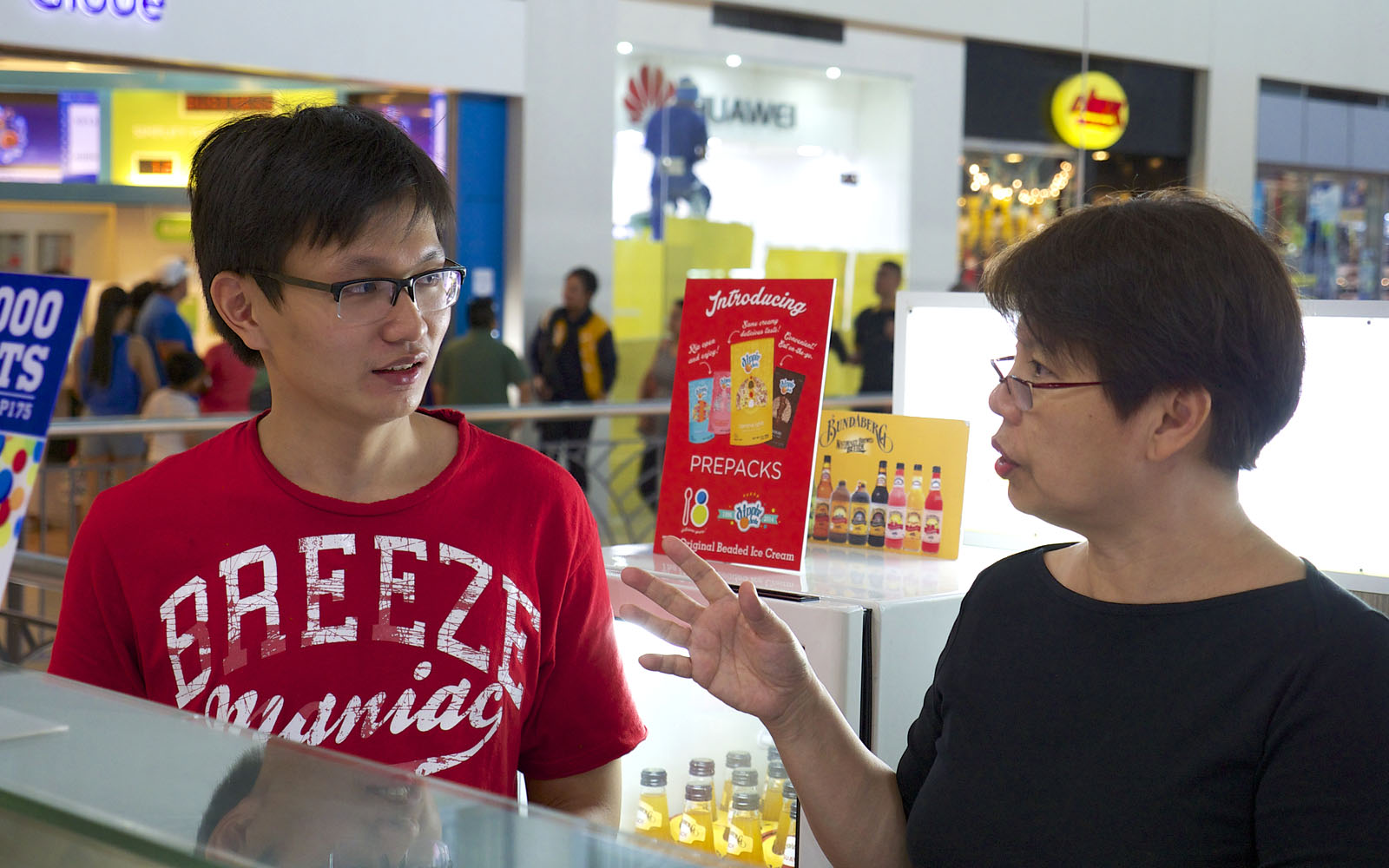 Dominic and his mum, Lucy Co, at one of her ice cream parlors. He helps out with designing brochures and other collateral.