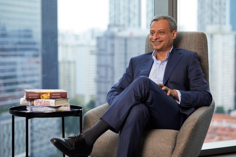 A man smiling and seated