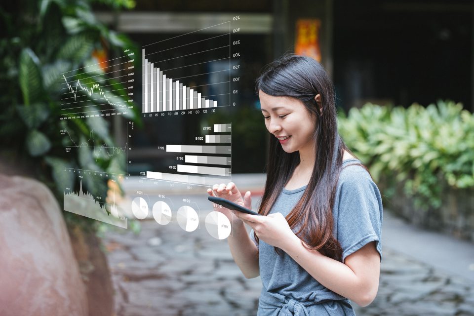 Young woman using smartphone analytics