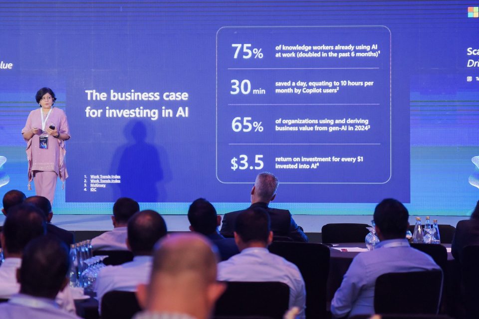 Person on a stage addressing an audience at an event