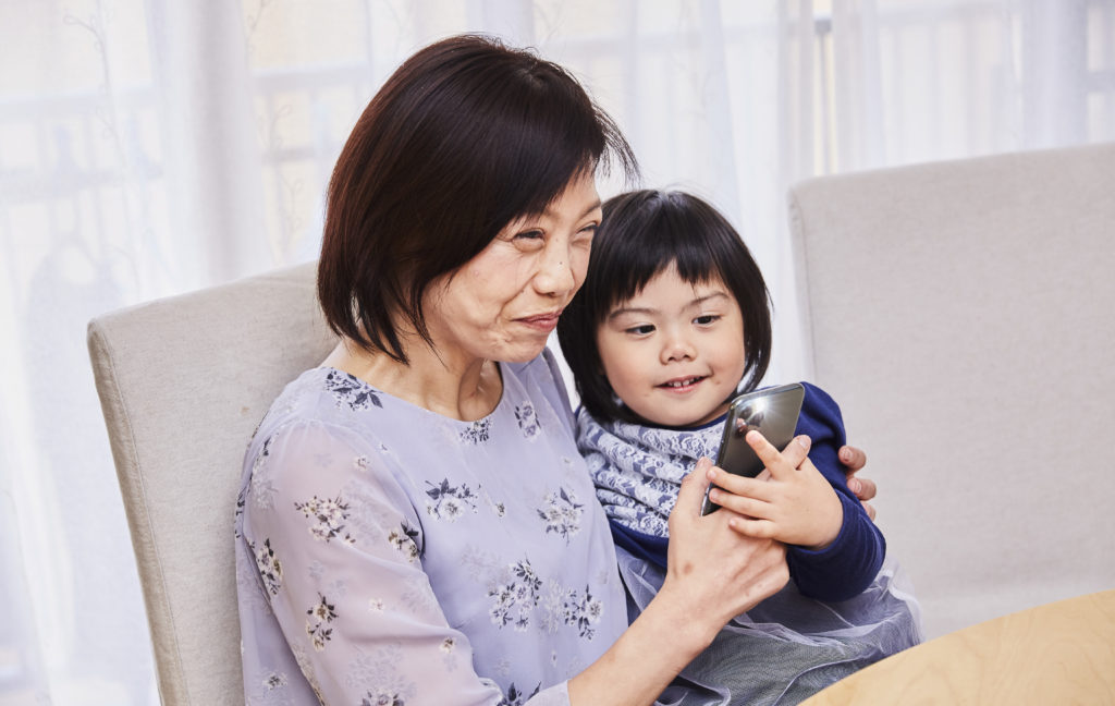 A toddler sitting on her mother's lap