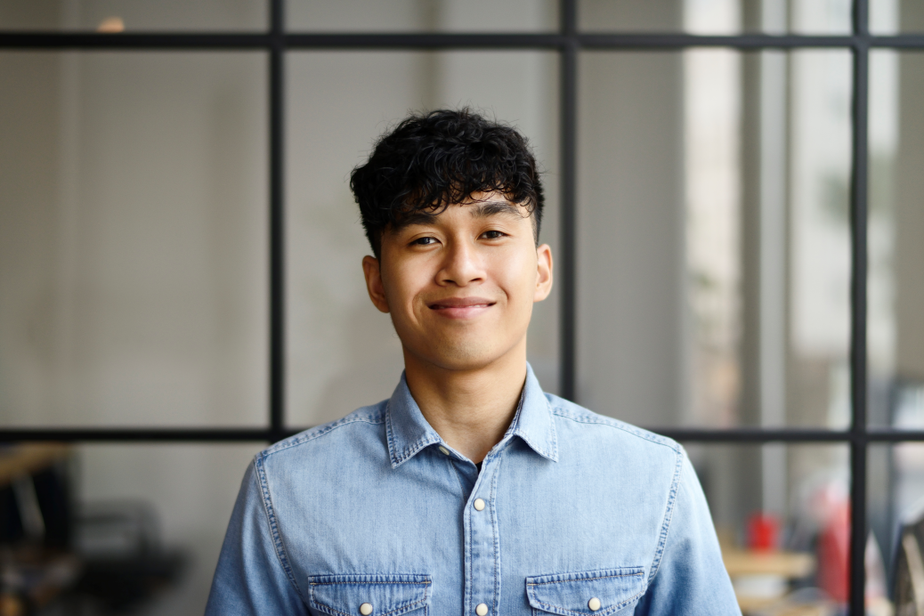 Portrait of a young Malay man in a modern office