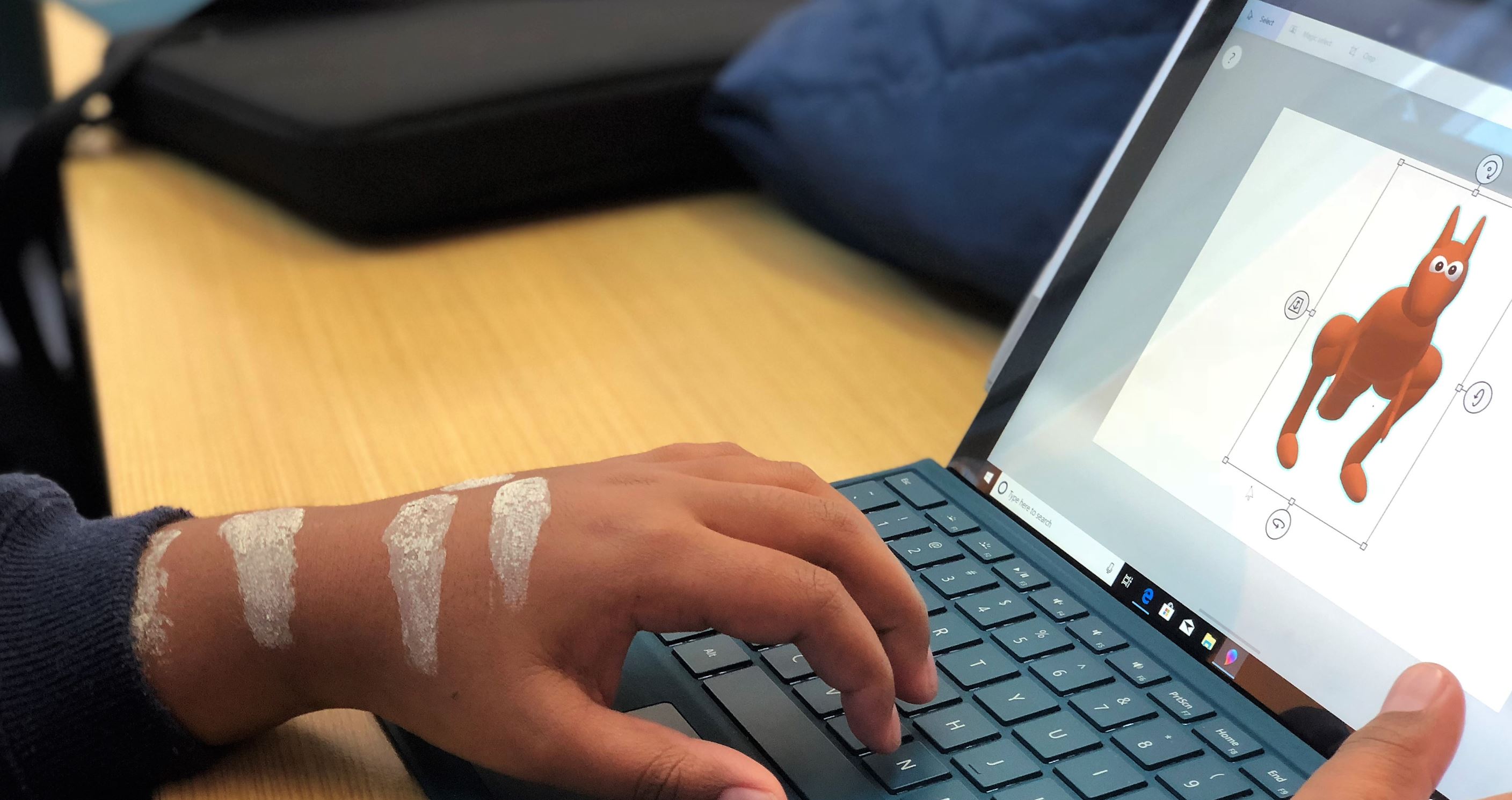 Young indigenous student using laptop