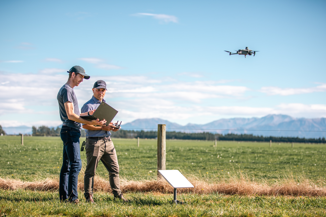 Men flying a drone
