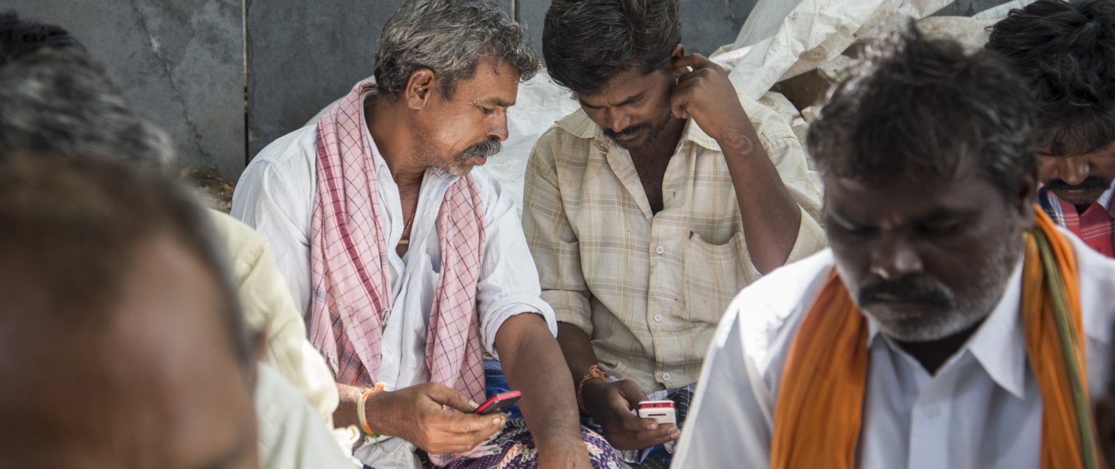 Farmer looking at their mobile phones