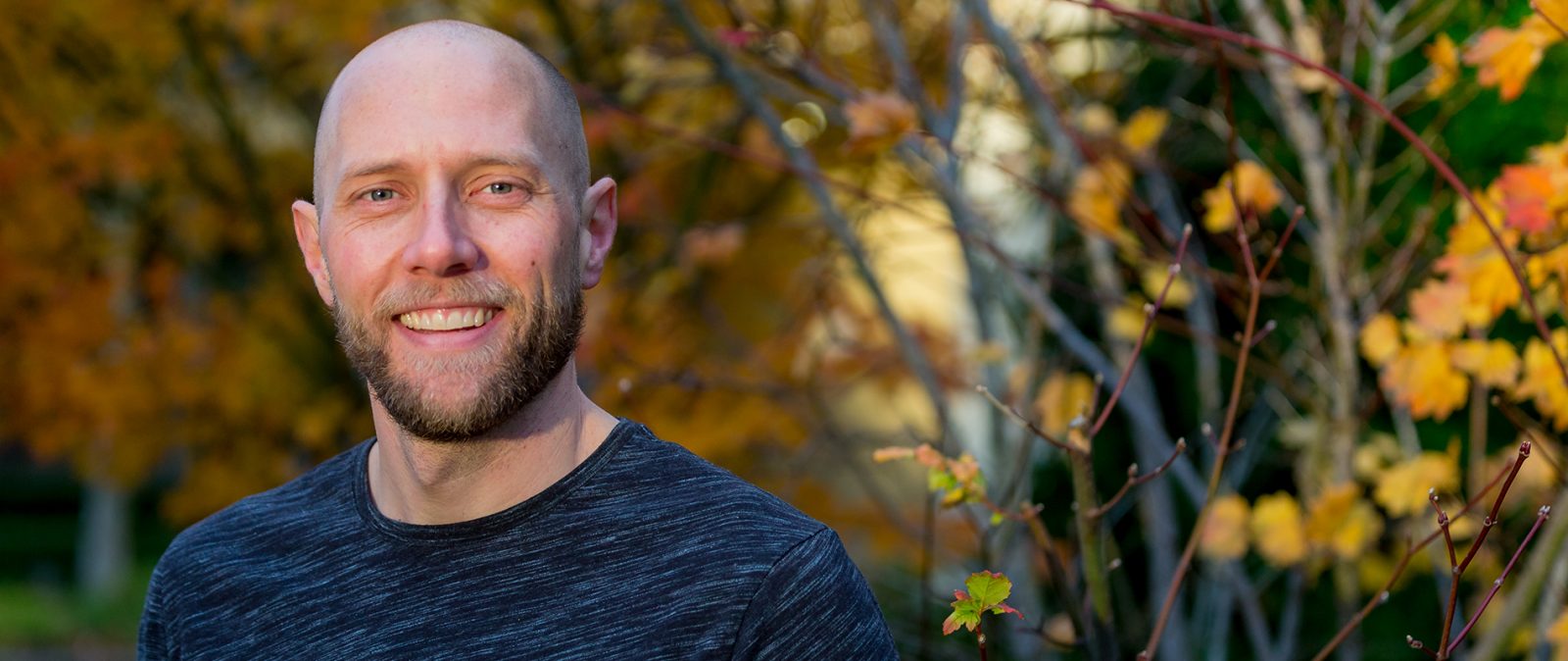A man standing in front of trees