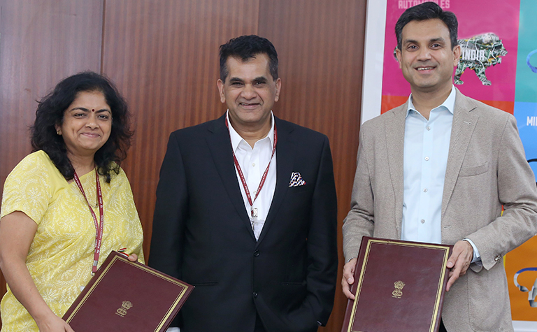 A woman and two men posing for the camera