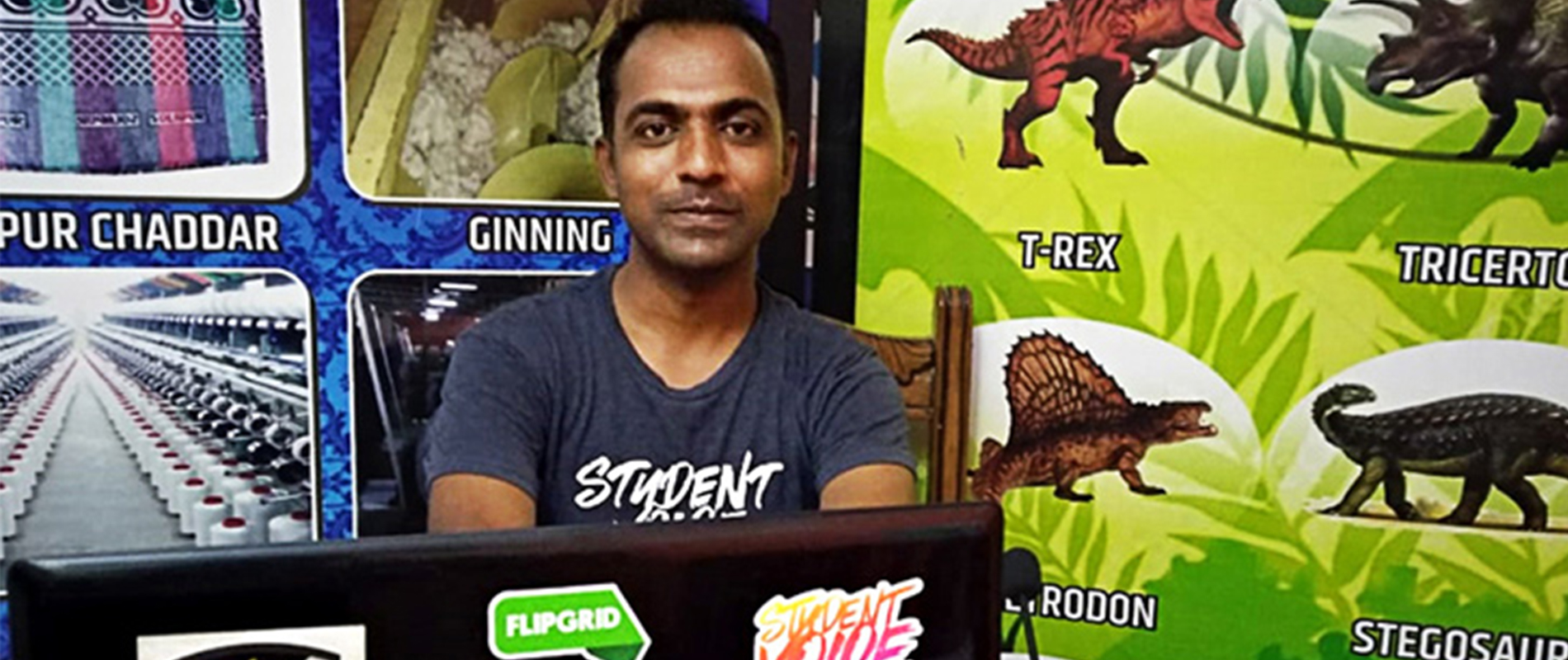 a man sitting in front of a laptop
