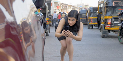 A girl clicking closeup picture of a car