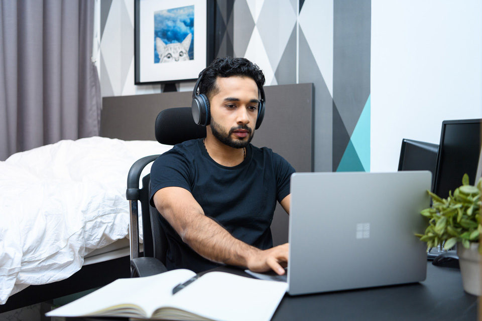 A male employee working from home on his laptop.