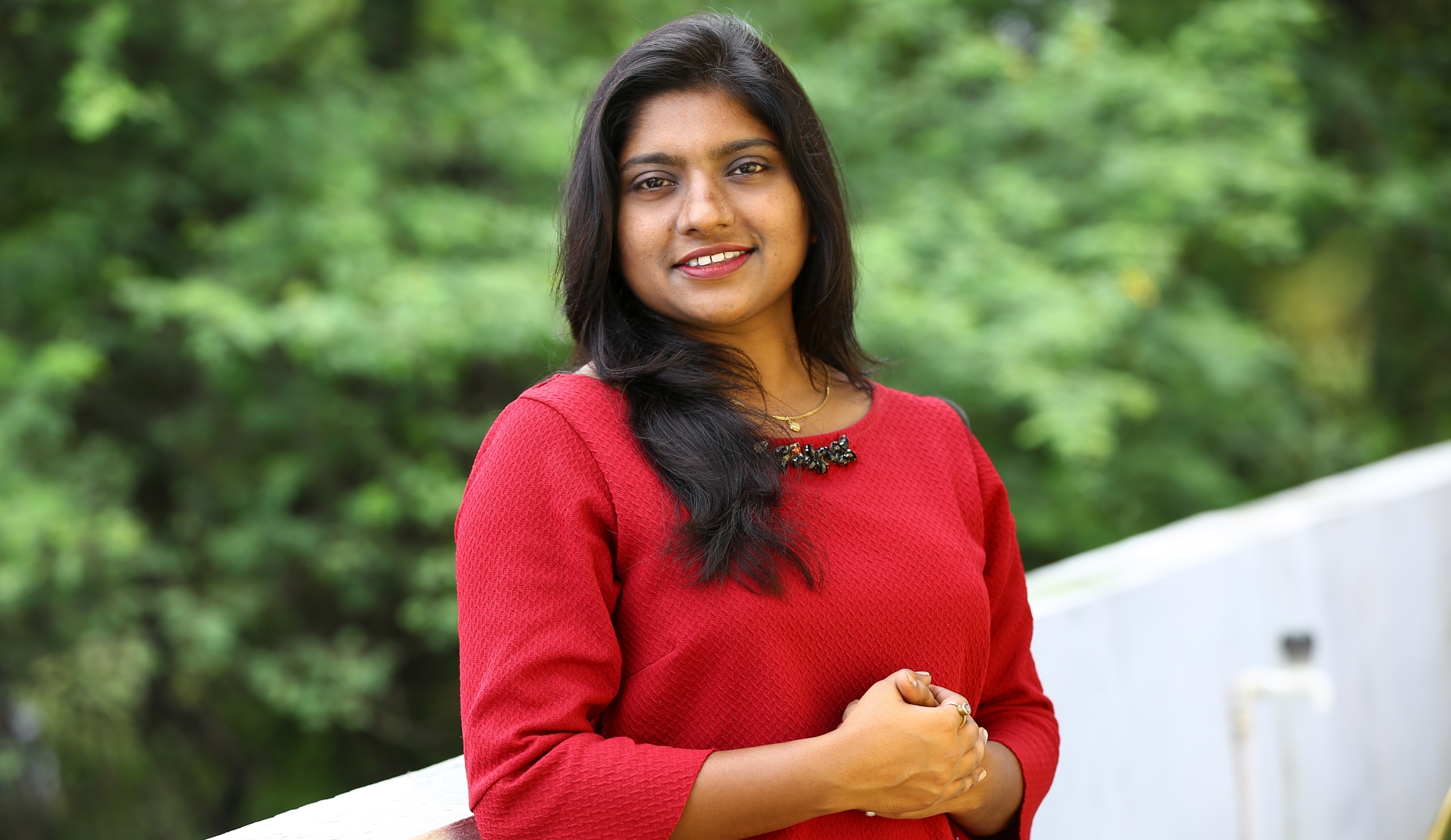 Photo of a young woman smiling at the camera.