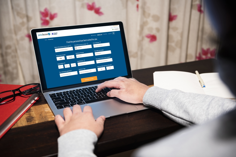 Photo of a person navigating the Paisabazaar website on a laptop