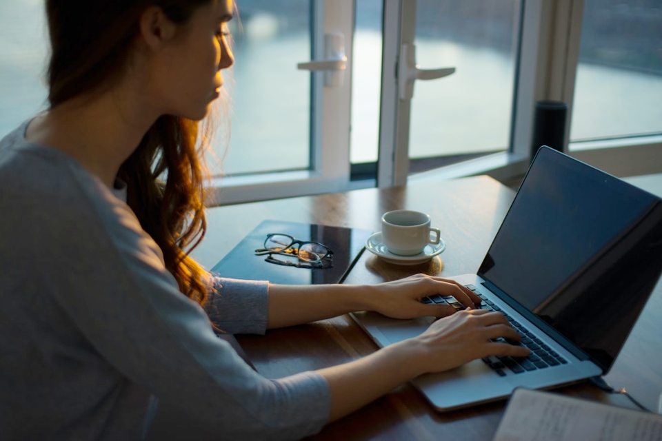 Photo of a woman working on a laptop