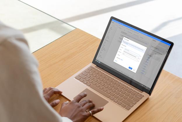 Image of a person working on a laptop
