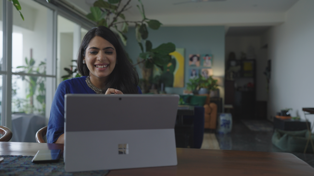 a woman working on a Surface Pro