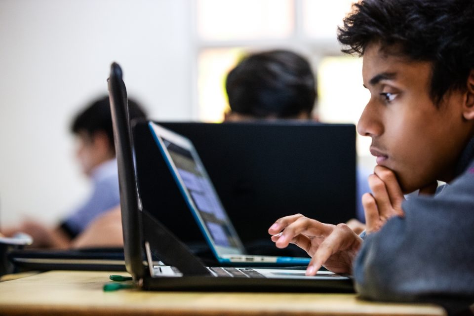 A child looking into a laptop screen