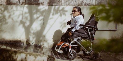 a man on a wheelchair climbing a ramp