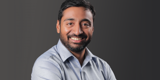 a man wearing a blue shirt looking at the camera