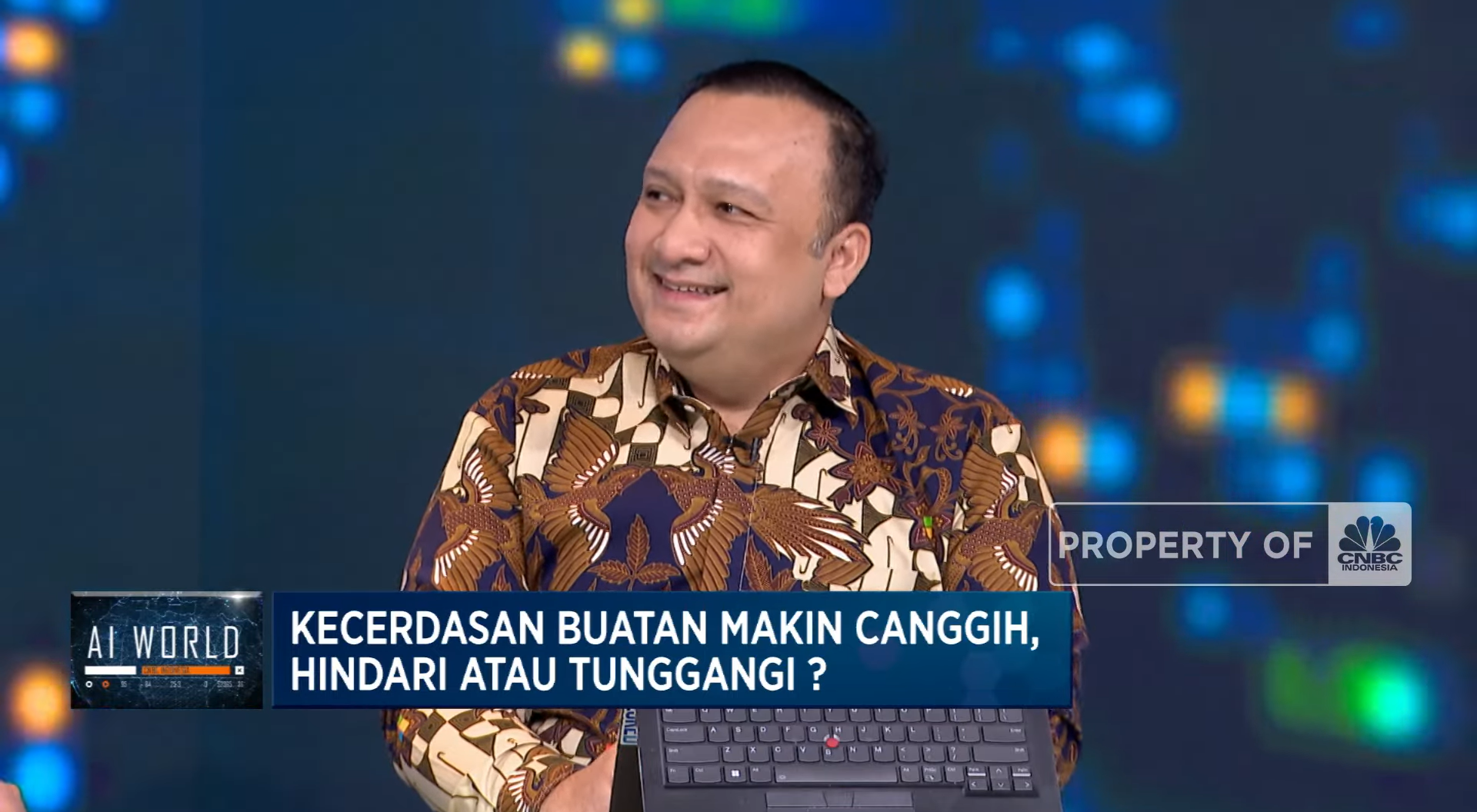 A man smiling during a media interview at a TV studio