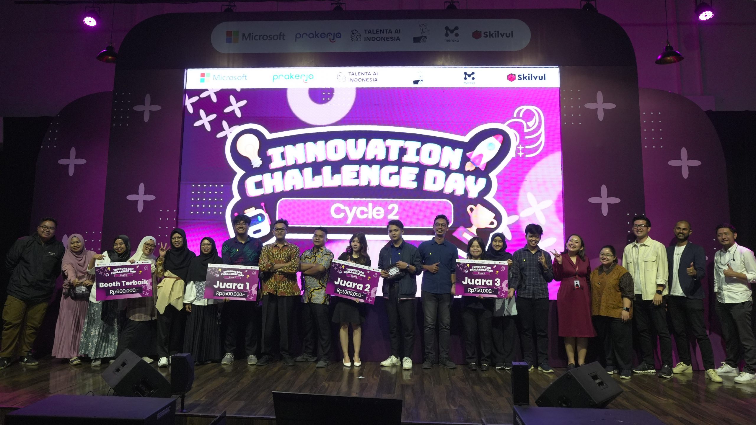 A group of young people from Indonesia who win the "Innovation Challenge Day" posing together on a stage. They are smiling and holding their winning plaque.
