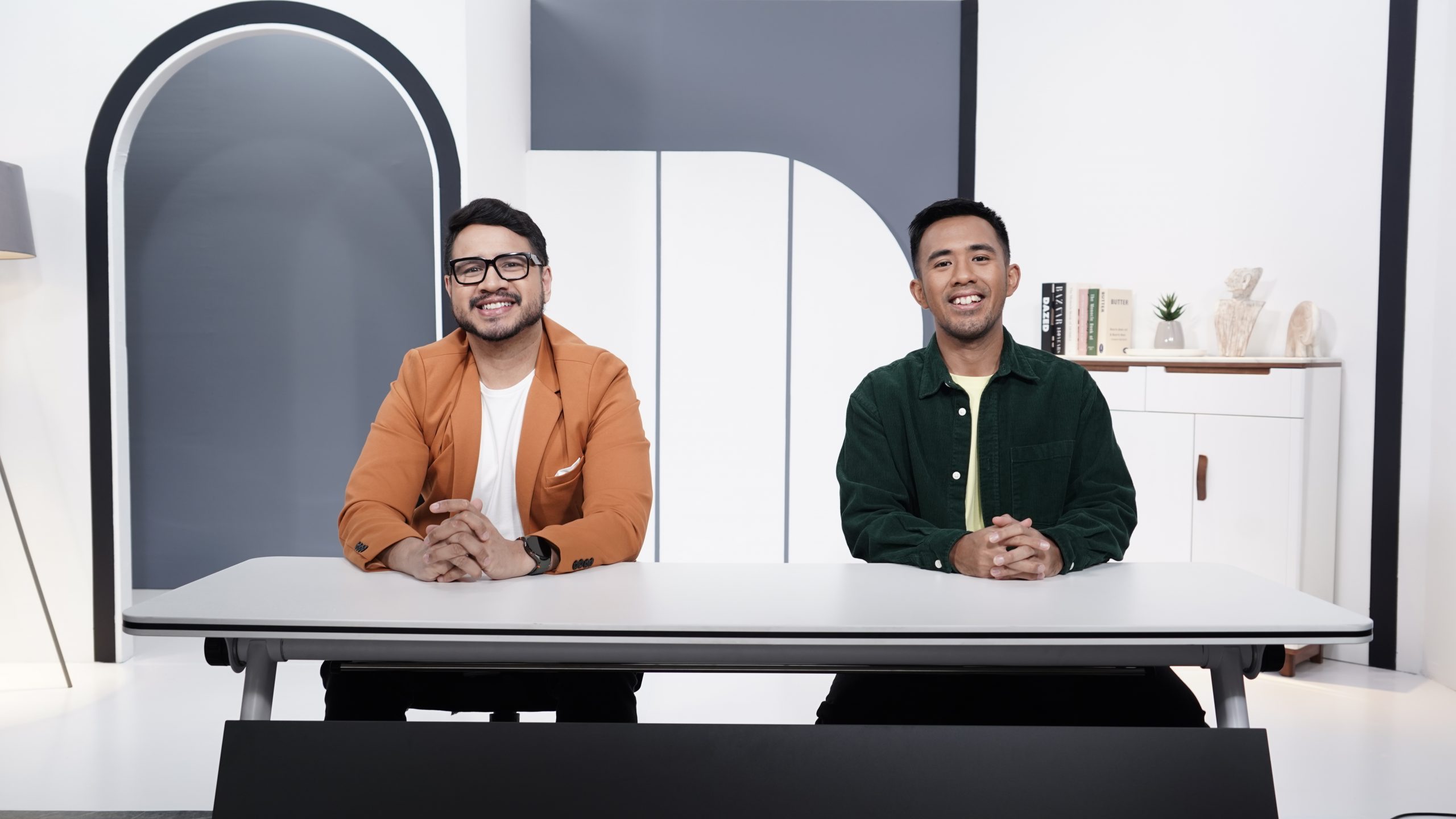 two men sitting down smiling