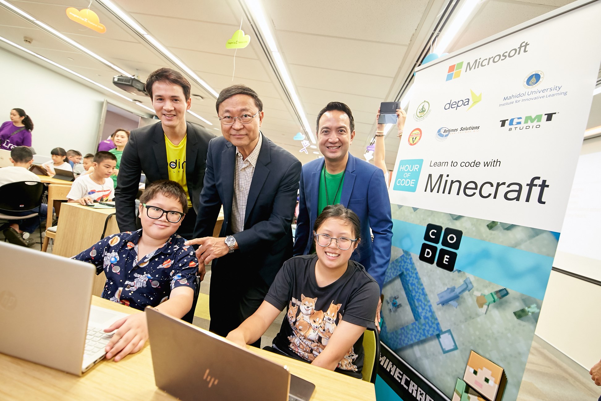 Executives and children in coding activity