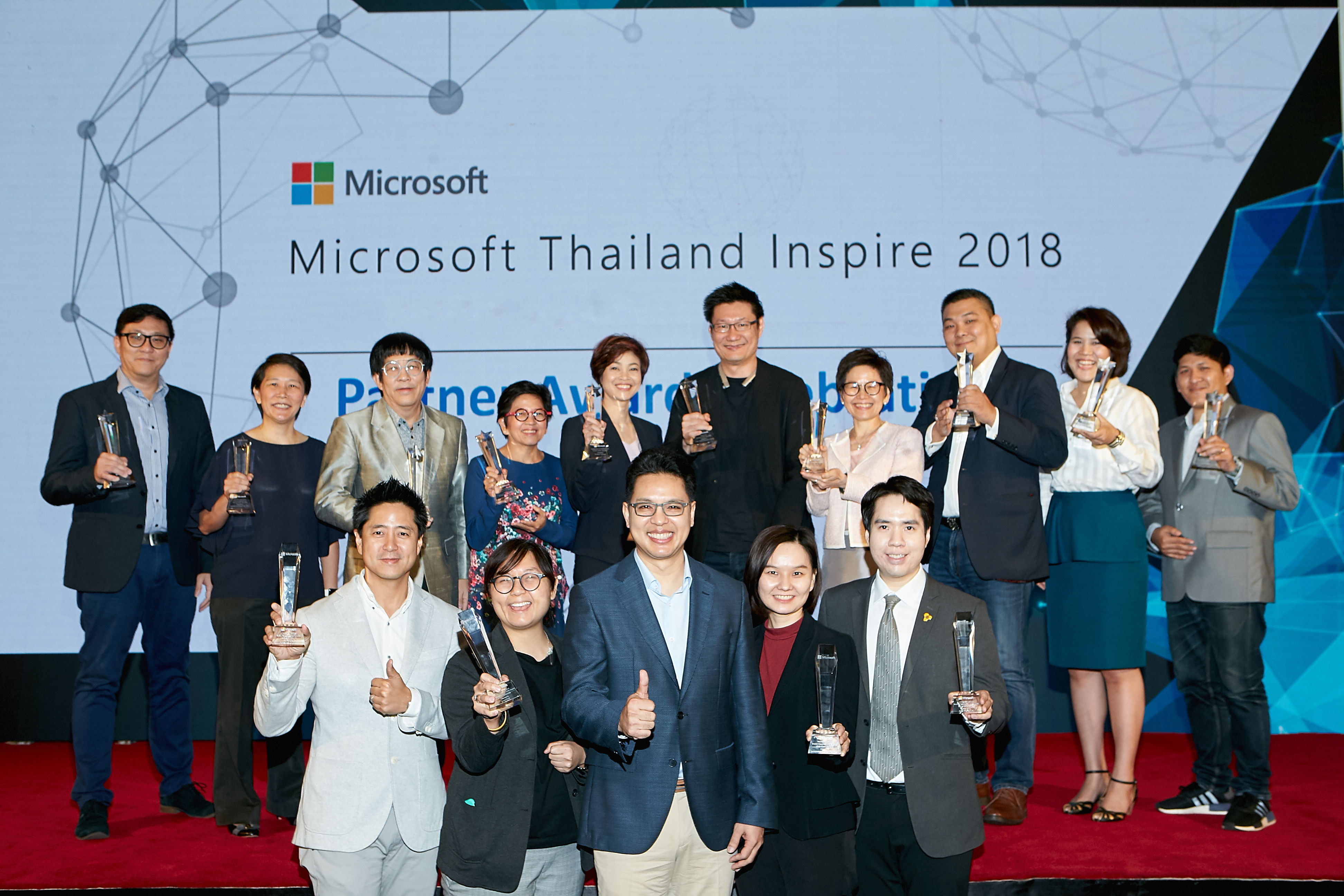 Group of people celebrating awards ceremony on stage